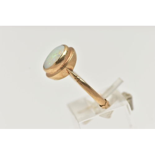 48 - A 9CT GOLD OPAL RING, designed with an oval opal cabochon, collet set to the yellow gold rim, pinche... 