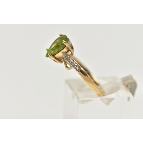 49 - A 9CT GOLD, PERIDOT AND DIAMOND RING, designed with a four claw set, pear cut peridot, flanked with ... 