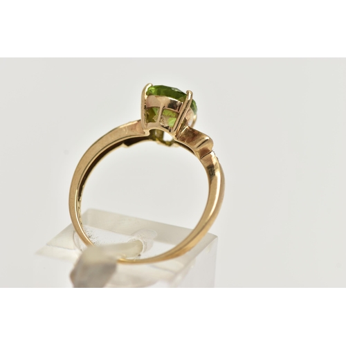 49 - A 9CT GOLD, PERIDOT AND DIAMOND RING, designed with a four claw set, pear cut peridot, flanked with ... 