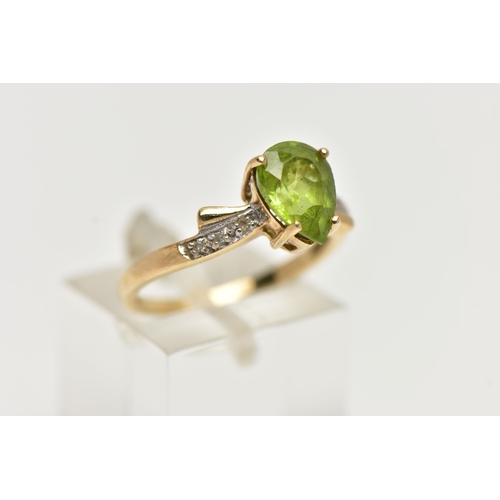 49 - A 9CT GOLD, PERIDOT AND DIAMOND RING, designed with a four claw set, pear cut peridot, flanked with ... 