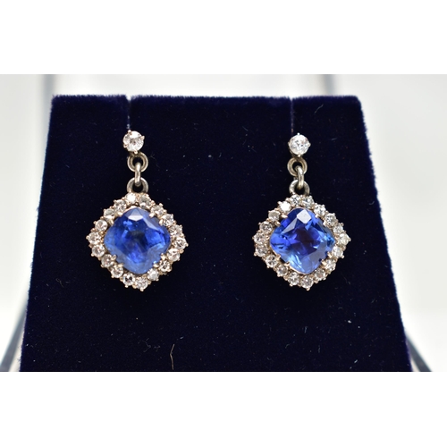 5 - A PAIR OF EARLY 20TH CENTURY SAPPHIRE AND DIAMOND EARRINGS, each earring set with a cushion cut sapp... 