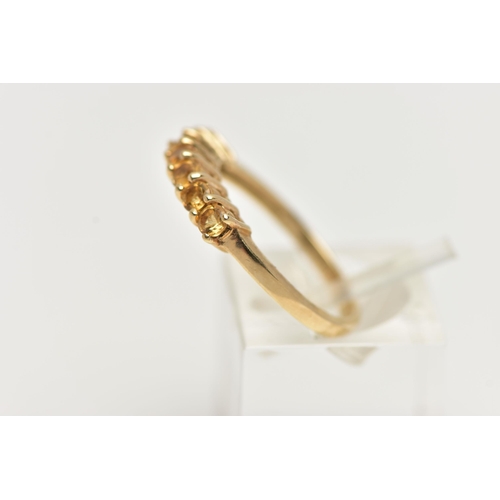 51 - A 9CT GOLD CITRINE RING, designed with a row of seven circular cut citrines, to the polished band, h... 