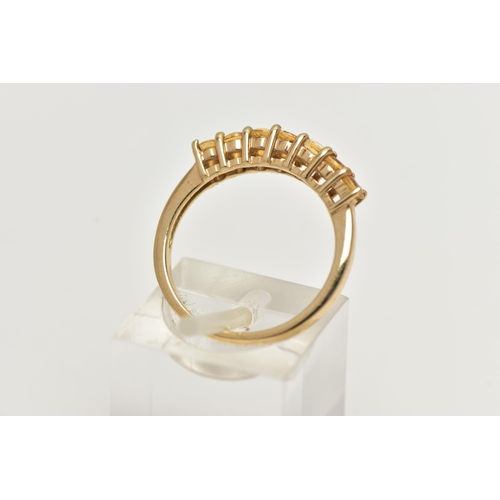 51 - A 9CT GOLD CITRINE RING, designed with a row of seven circular cut citrines, to the polished band, h... 