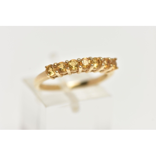 51 - A 9CT GOLD CITRINE RING, designed with a row of seven circular cut citrines, to the polished band, h... 