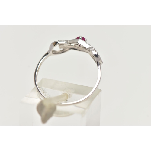 53 - A 9CT WHITE GOLD RUBY RING, designed with a claw set, circular cut ruby, in an openwork mount leadin... 