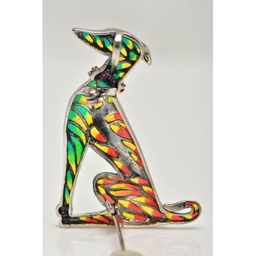 55 - A WHITE METAL PLIQUE A JOUR BROOCH, in the form of a seated dog, decorated with red, green and yello... 