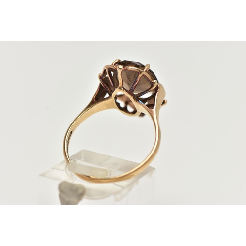 57 - A 9CT GOLD SMOKY QUARTZ RING, designed with a claw set, oval cut smoky quartz, within an openwork su... 