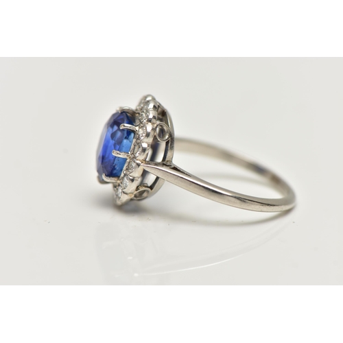 6 - A SAPPHIRE AND DIAMOND CLUSTER RING, set with a mixed cut, cushion sapphire, measuring approximately... 