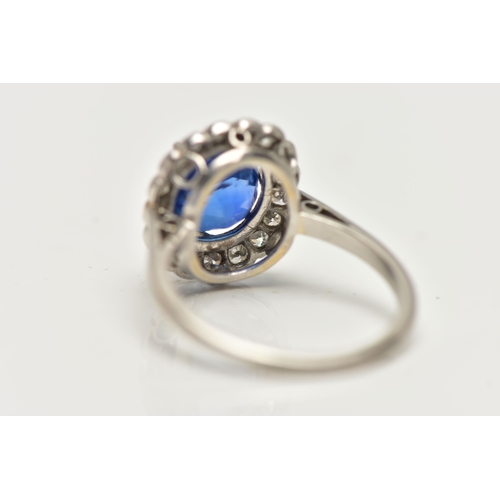 6 - A SAPPHIRE AND DIAMOND CLUSTER RING, set with a mixed cut, cushion sapphire, measuring approximately... 