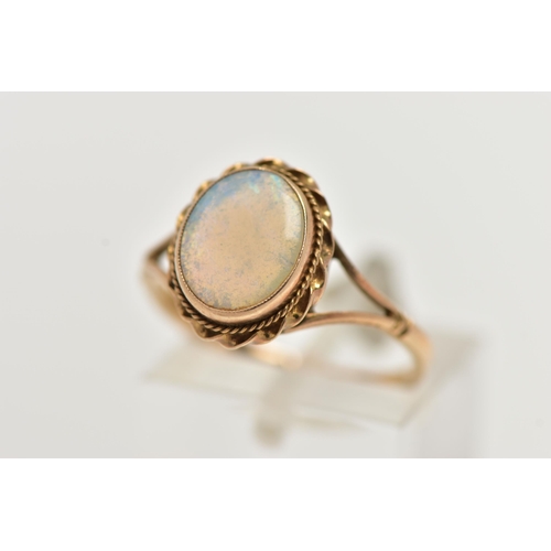 60 - A 9CT GOLD OPAL RING, designed with an opal cabochon, in a milgrain collet setting, to a rope twist ... 