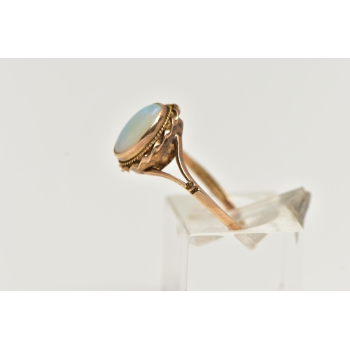 60 - A 9CT GOLD OPAL RING, designed with an opal cabochon, in a milgrain collet setting, to a rope twist ... 