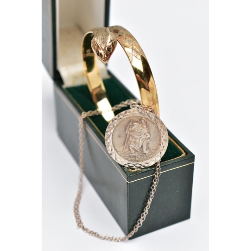 69 - A GOLD PLATED SNAKE BANGLE AND A SILVER ST. CHRISTOPHER PENDANT NECKLACE, a textured gold plated hin... 