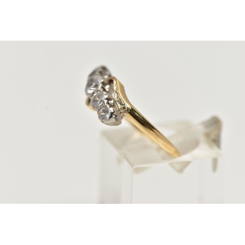 70 - A YELLOW METAL GEM SET RING, designed with a row of five graduated colourless spinels in a white met... 