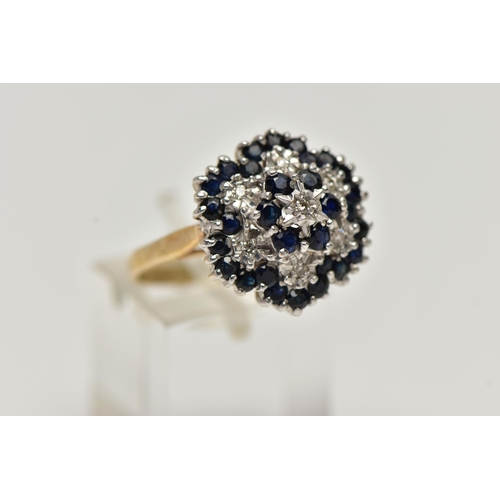 72 - A 9CT GOLD CLUSTER RING, seven single cut diamonds set with thirty circular cut blue sapphires, lead... 