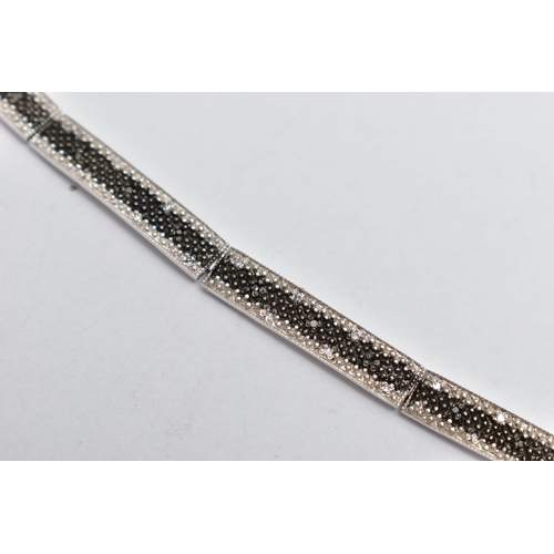 73 - A 9CT GOLD DIAMOND BRACELET, a white gold line bracelet comprised of eight panels, detailed with a c... 