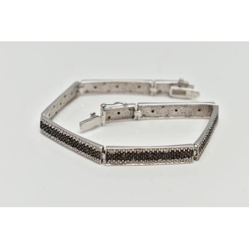 73 - A 9CT GOLD DIAMOND BRACELET, a white gold line bracelet comprised of eight panels, detailed with a c... 