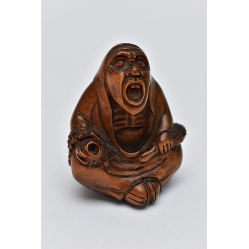 75 - A CARVED NETSUKE FIGURE, in the form of a seated robed elder, drill holes to the back, approximate h... 