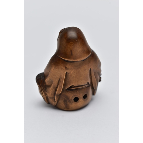 75 - A CARVED NETSUKE FIGURE, in the form of a seated robed elder, drill holes to the back, approximate h... 