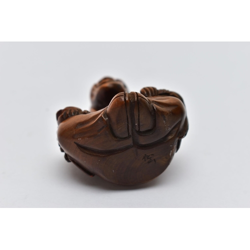 75 - A CARVED NETSUKE FIGURE, in the form of a seated robed elder, drill holes to the back, approximate h... 