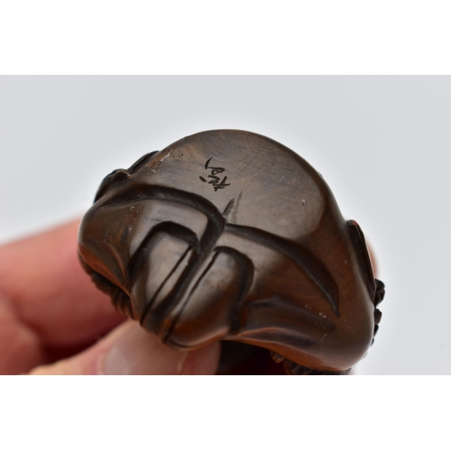 75 - A CARVED NETSUKE FIGURE, in the form of a seated robed elder, drill holes to the back, approximate h... 