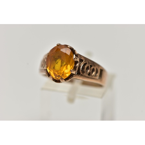 89 - A 9CT GOLD GEMSTONE RING, designed with a six claw set, oval cut orange stone assessed as sapphire, ... 