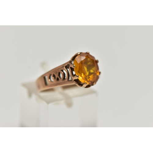 89 - A 9CT GOLD GEMSTONE RING, designed with a six claw set, oval cut orange stone assessed as sapphire, ... 