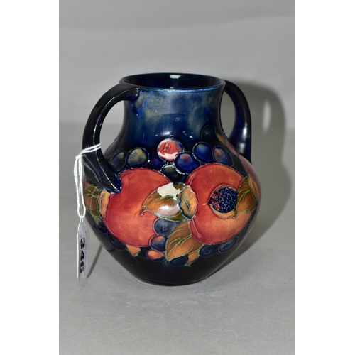 346 - A MOORCROFT POTTERY POMEGRANATE TWIN HANDLED VASE, of amphora style, tube lined with pomegranates an... 