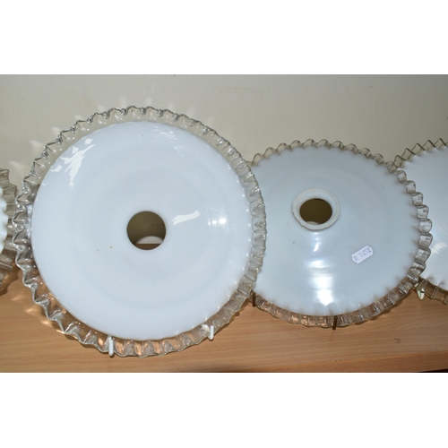 354 - FOUR GLASS LAMPSHADES, each in white opaque glass with a clear wavy edge, slight variations in size ... 