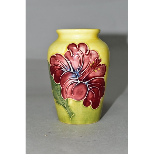 356 - A SMALL MOORCROFT POTTERY HIBISCUS VASE, tube lined with red/purple hibiscus on a graduated yellow a... 