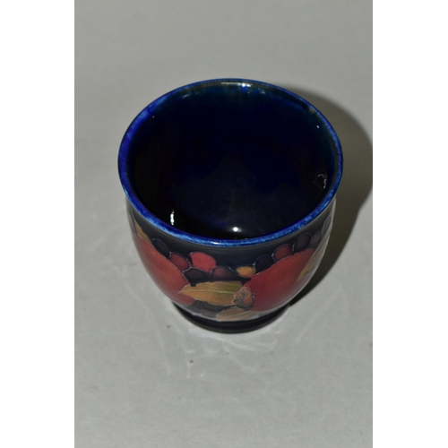 361 - A SMALL MOORCROFT POTTERY POMEGRANATE PLANTER,  tube lined with pomegranates and berries on a navy b... 