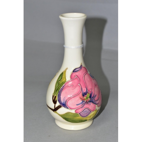 367 - A MOORCROFT POTTERY MAGNOLIA VASE, of bottle form, decorated with tube lined pink Magnolia pattern o... 