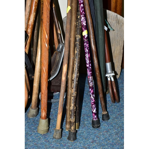 395 - A LARGE QUANTITY OF WALKING STICKS AND A SET VINTAGE GOLF CLUBS, to include a set of Dunlop 'Arnold ... 