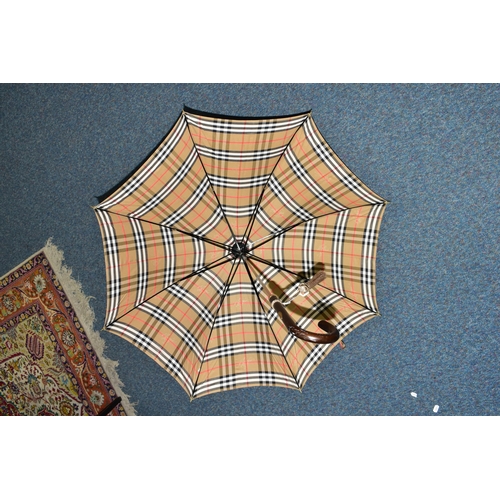 396 - A BURBERRYS OF LONDON (BURBERRY) LADIES UMBRELLA, in the brands signature beige check print, with ta... 