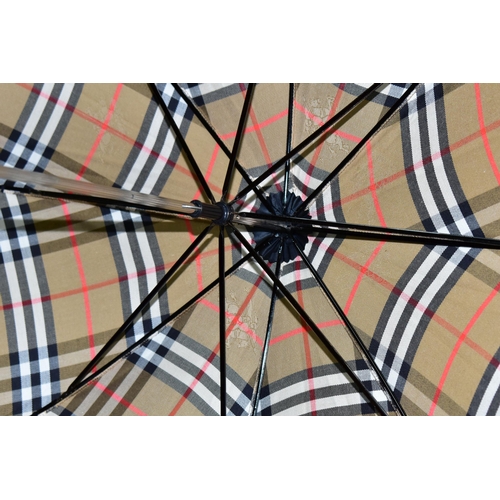 396 - A BURBERRYS OF LONDON (BURBERRY) LADIES UMBRELLA, in the brands signature beige check print, with ta... 