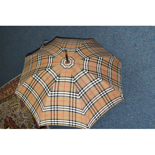 396 - A BURBERRYS OF LONDON (BURBERRY) LADIES UMBRELLA, in the brands signature beige check print, with ta... 