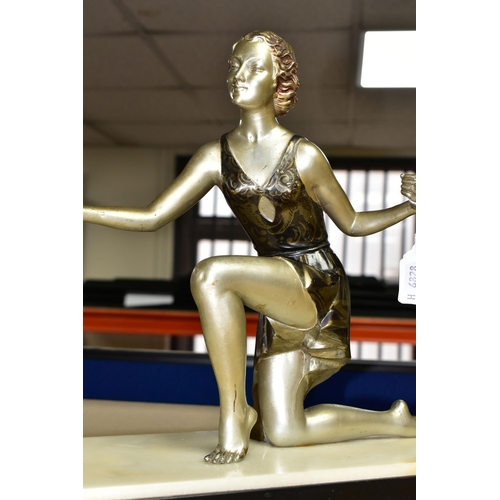 399 - AN ART DECO FIGURAL PHOTOGRAPH FRAME, the painted spelter kneeling female figure, wearing a short fl... 