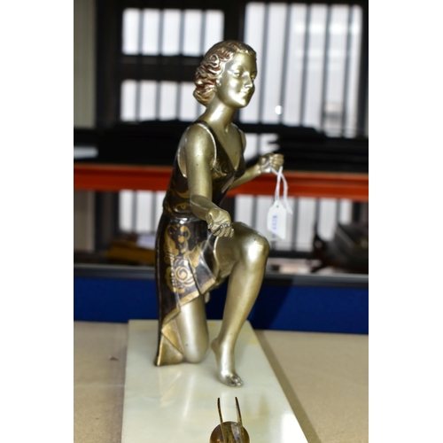 399 - AN ART DECO FIGURAL PHOTOGRAPH FRAME, the painted spelter kneeling female figure, wearing a short fl... 