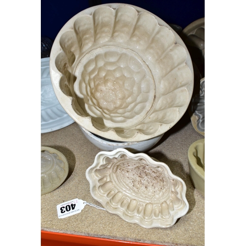 403 - TEN CERAMIC JELLY MOULDS, of varied sizes and designs, to include late Victorian/Edwardian and later... 