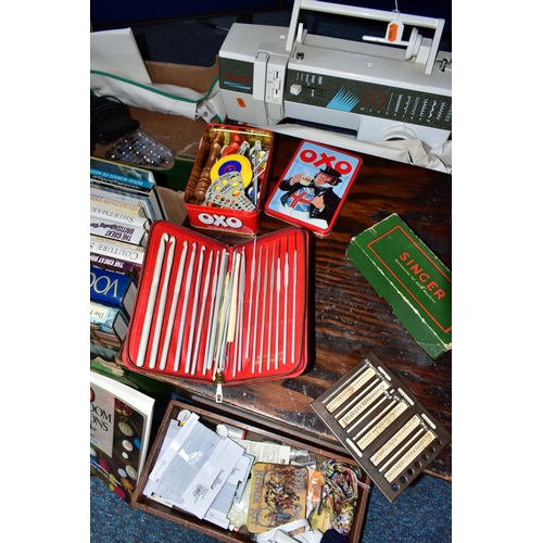 412 - TWO BOXES AND LOOSE SEWING MACHINE, ACCESSORIES, HABERDASHERY AND SEWING BOOKS, to include a Singer ... 