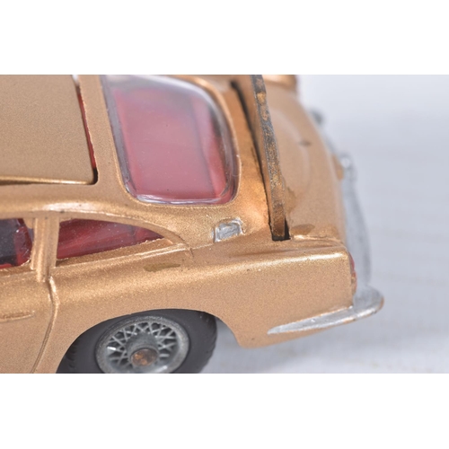 155 - A BOXED CORGI TOYS JAMES BOND ASTON MARTIN D.B.5, No.261, an example of the rarer toffee gold versio... 