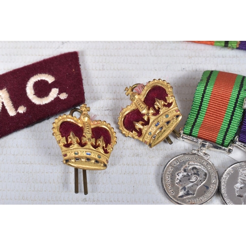 223 - AN OFFICERS TERRATORIAL MINITURE MEDAL GROUP, two crowns, a RAMC shoulder title badge and a ribbon b... 