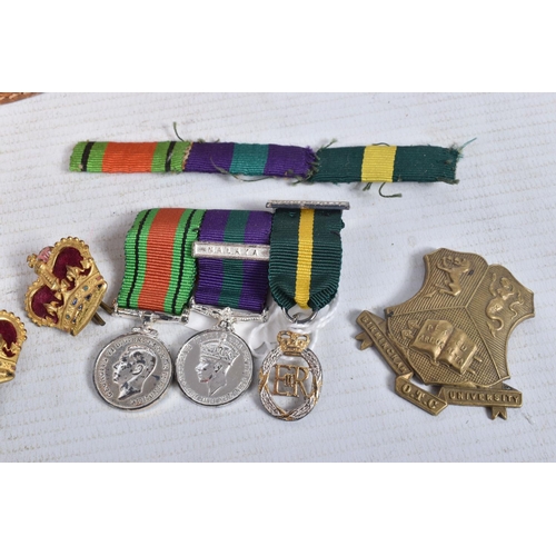 223 - AN OFFICERS TERRATORIAL MINITURE MEDAL GROUP, two crowns, a RAMC shoulder title badge and a ribbon b... 