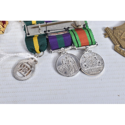 223 - AN OFFICERS TERRATORIAL MINITURE MEDAL GROUP, two crowns, a RAMC shoulder title badge and a ribbon b... 