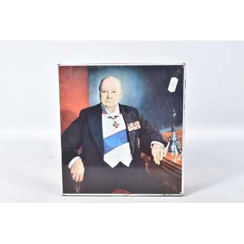 226 - A WINSTON CHURCHILL BISCUIT TIN, containing a hallmarked silver cigarette holder, a cased set of bin... 