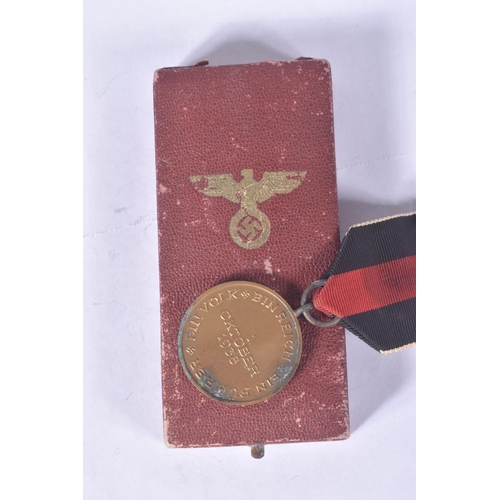 259 - THREE GERMAN MEDALS, to include a Sudetenland medal, Anschluss Commemorative medal and an eastern fr... 