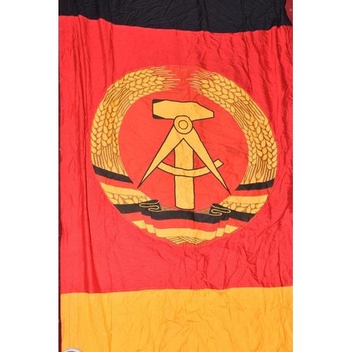 285 - TWO EAST GERMAN DDR FLAGS AND A BANNER, these all vary in size, the banner is in good condition and ... 