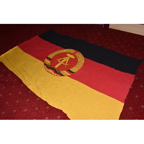 285 - TWO EAST GERMAN DDR FLAGS AND A BANNER, these all vary in size, the banner is in good condition and ... 