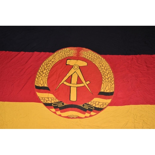 285 - TWO EAST GERMAN DDR FLAGS AND A BANNER, these all vary in size, the banner is in good condition and ... 