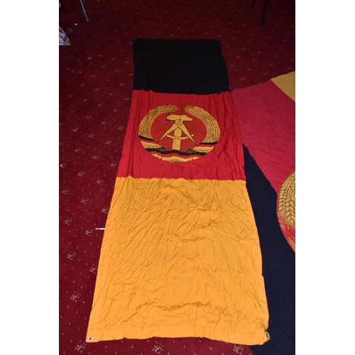 285 - TWO EAST GERMAN DDR FLAGS AND A BANNER, these all vary in size, the banner is in good condition and ... 