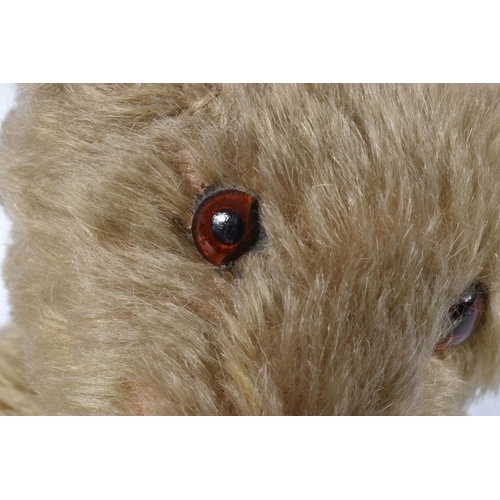 63 - A GERMAN BLONDE MOHAIR TEDDY BEAR, c.1914 - 1920, original glued amber and black glass eyes (both wi... 